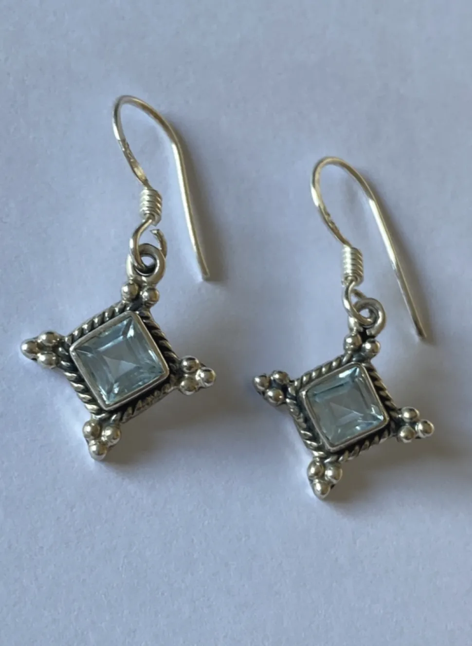 solid_silver_blue_topaz_d_1.webp Solid Silver Blue Topaz Diamond shaped Drop Earrings