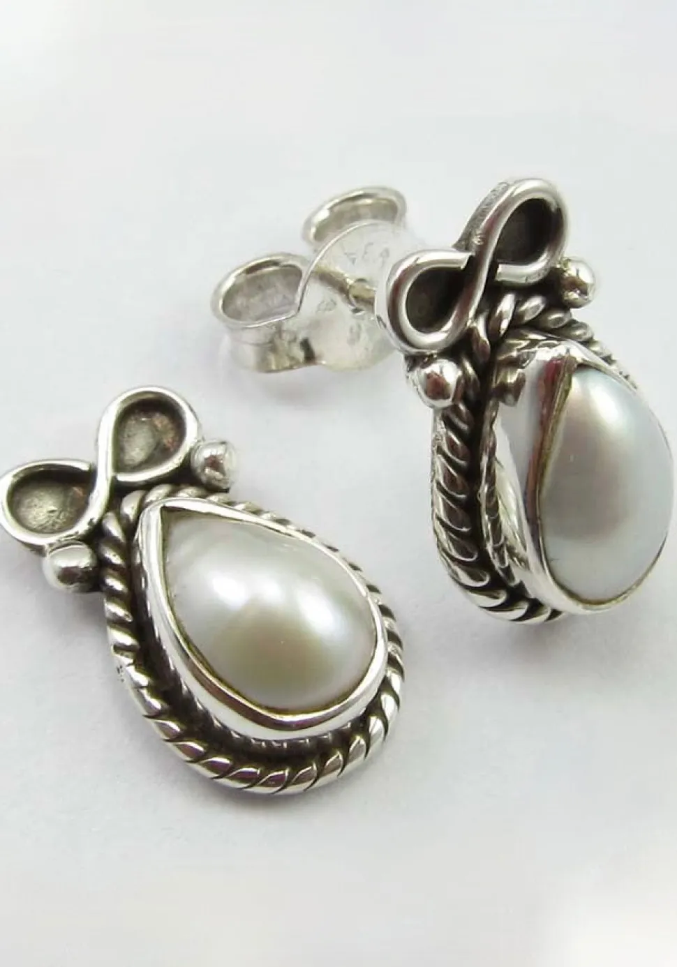 solid_silver_pearl_and_bo_0.webp Solid Silver Pearl and Bow Stud Earrings