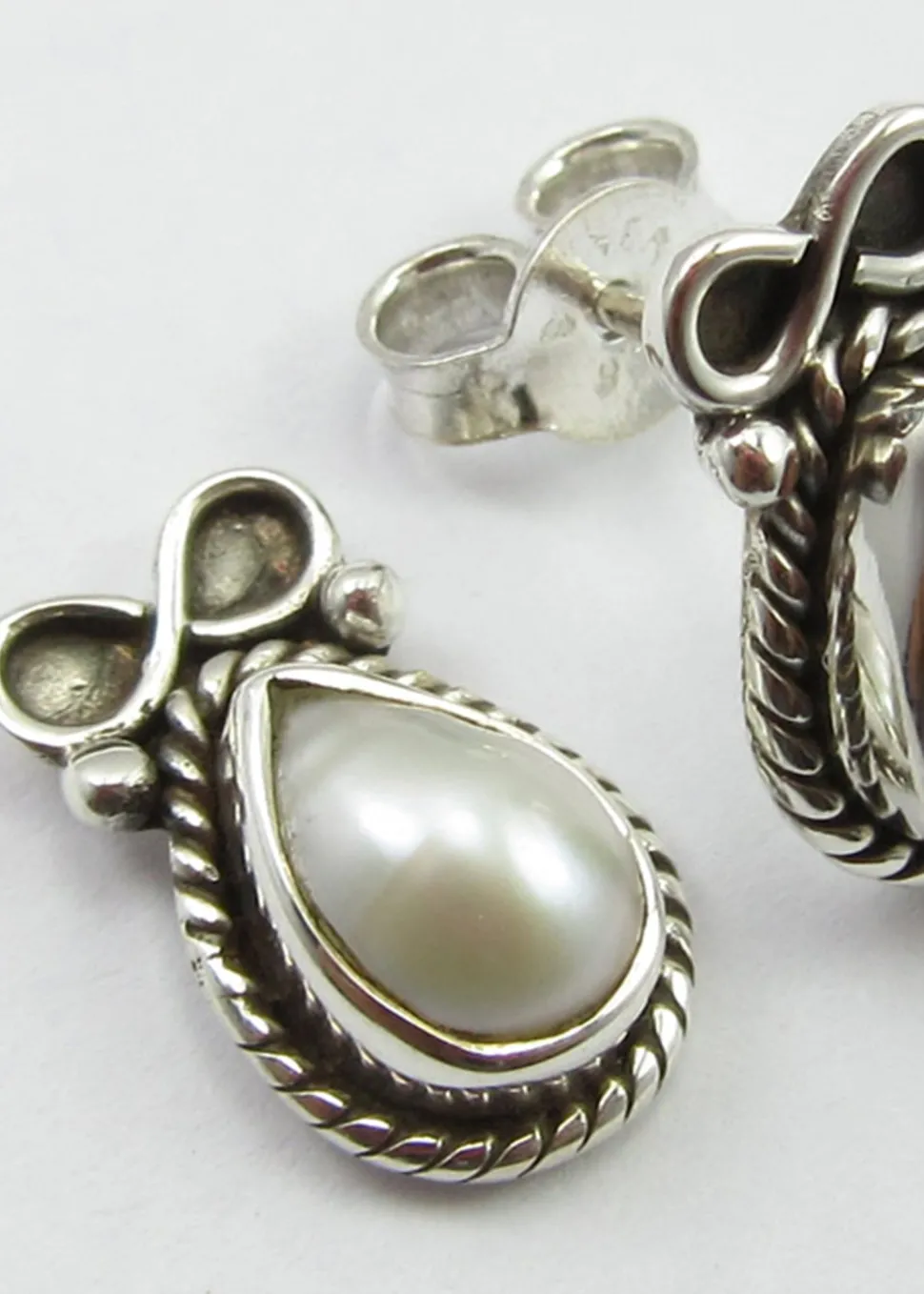 solid_silver_pearl_and_bo_1.webp Solid Silver Pearl and Bow Stud Earrings